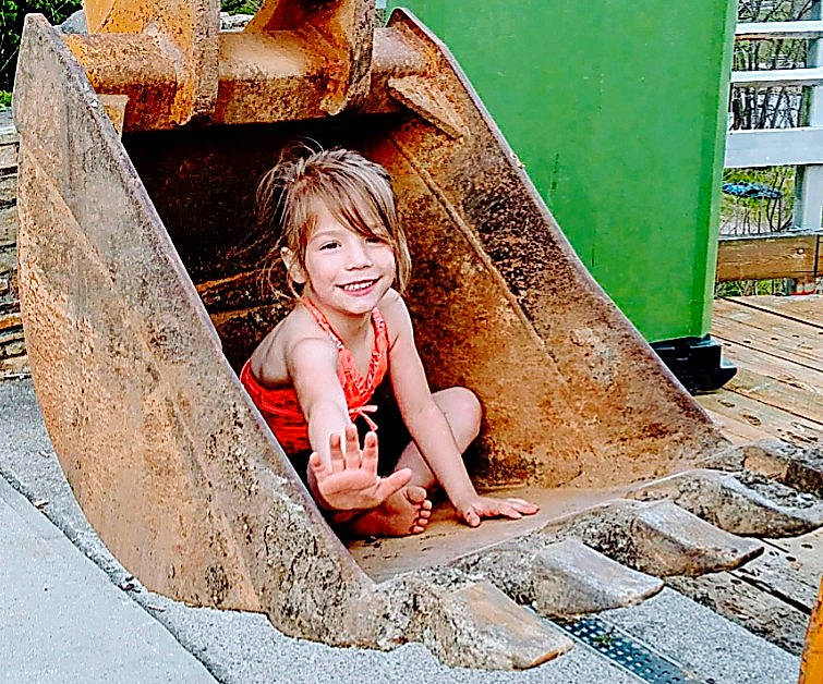 Layla is registered to the contest to win money with this photo: automotive_wheel_system, brick, child, concrete, flash_photography, flooring, fun, grass, happy, human_leg, joy, leisure, people_in_nature, person, road_surface, rock, sidewalk, sitting, smile, soil