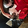 cat, tabby_cat, pet, animal, hand, person, blanket, red_blanket, fur, indoor, resting, comfort, cuddle, lap, relaxed, cozy, home, soft, texture, black_pants