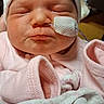 Marie is registered to the contest to win money with this photo: newborn, baby, sleeping, infant, portrait, pink_clothing, white_hat, blanket, medical_tape, hospital, close_up, face, eyes_closed, peaceful, cozy, swaddled, hands, indoors, photography, adorable
