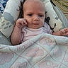 baby, infant, child, portrait, face, eyes, sitting, lying_down, smiling, pink_clothing, blanket, quilt, pillow, cushion, outdoor, garden, hose, cozy, family_photo, close_up