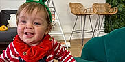Colby is registered to the contest to win money with this photo: toddler, child, smiling, holiday, christmas, reindeer_antlers, red_sweater, striped_clothing, indoor, couch, green_couch, wicker_chair, wall_hanging, decor, flooring, happy, person, jingle_bells, festive, portrait