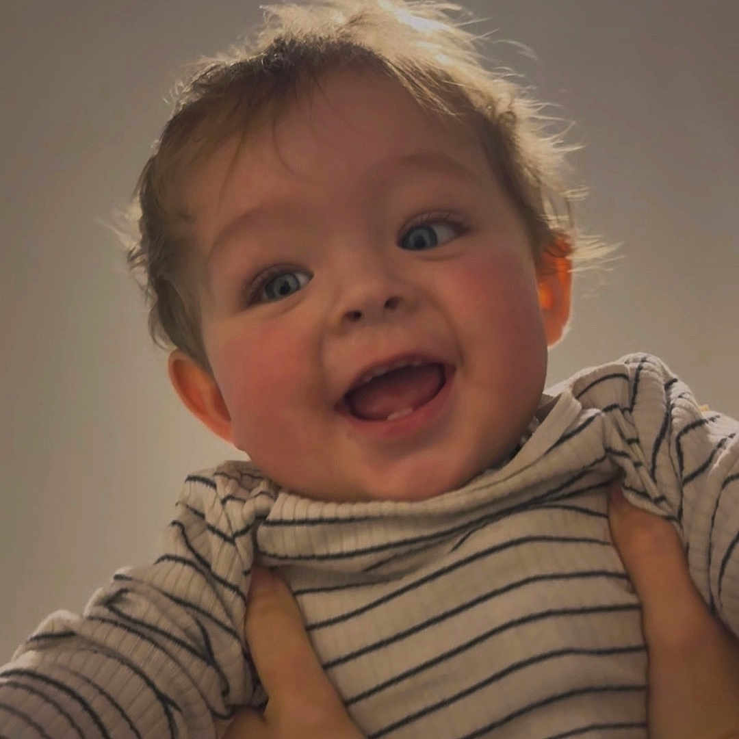 Colby joined the competition — help win amazing prizes! baby, child, cute, expression, face, hands, happy, indoor, infant, joy, light, person, playful, portrait, skin, smiling, striped_clothing, toddler, warm, young_child