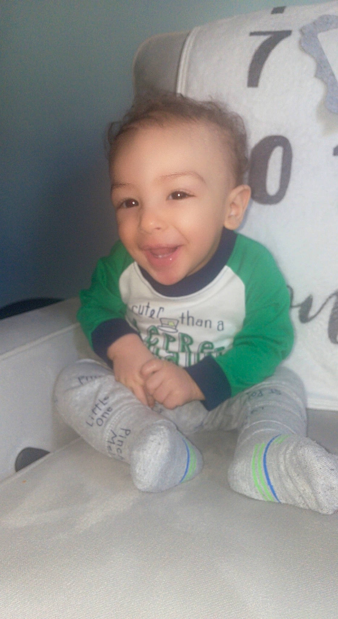 Carmelo is registered to the contest to win money with this photo: baby, baby_toddler_clothing, cheek, comfort, cool, finger, floor, flooring, fun, hair, happy, head, iris, joy, leg, person, product, skin, smile, sock