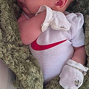 Grayson is registered to the contest to win money with this photo: newborn, baby, sleeping, blanket, onesie, white_clothing, mittens, infant, closeup, resting, soft_texture, cozy, cute, face, head, skin, peaceful, portrait, indoors, child