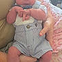 Grayson is registered to the contest to win money with this photo: baby, infant, sleeping, clothing, romper, bow_tie, arms, person, hand, socks, blanket, fabric, indoor, cute, newborn, skin, face, legs, comfort, rest