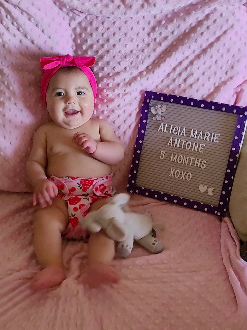 Alicia is registered to the contest to win money with this photo: baby, baby_toddler_clothing, beauty, child, diaper, fawn, finger, foot, happy, headpiece, headwear, human_leg, joy, magenta, person, pink, product, purple, skin, smile