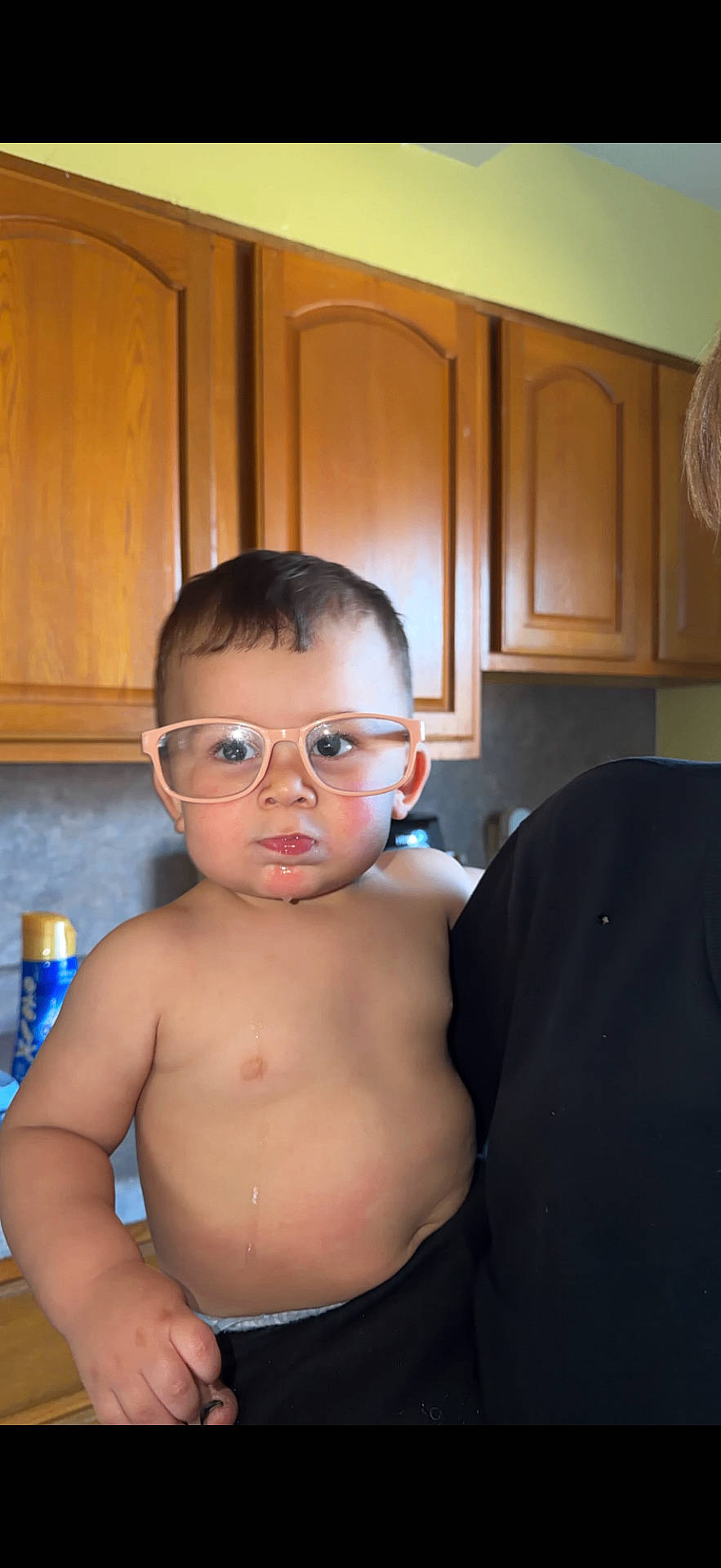 Xavier joined the competition — help win amazing prizes! adult, cabinet, child, countertop, expression, face, glasses, holding, home, household, indoor, kitchen, person, plump, serious, shirtless, short_hair, skin, toddler, wooden_cabinets