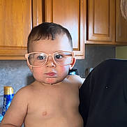 Xavier joined the competition — help win amazing prizes! toddler, child, glasses, drool, kitchen, cabinet, wood, person, baby, shirtless, cute, indoors, holding, portrait, expression, face, chubby, young, human, eyewear