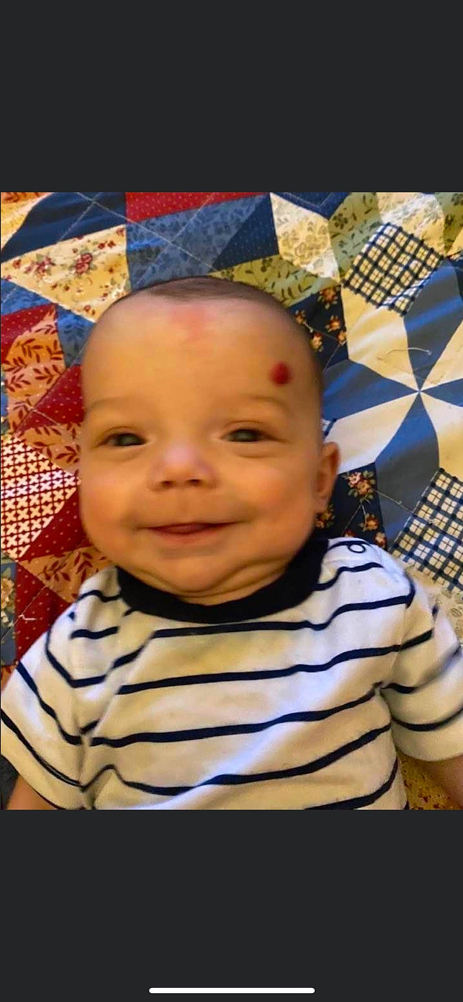 Ledger is registered to the contest to win money with this photo: art, baby, baby_laughing, baby_toddler_clothing, cheek, child, chin, facial_expression, flooring, fun, happy, iris, joy, linens, mouth, nose, pattern, people, person, smile
