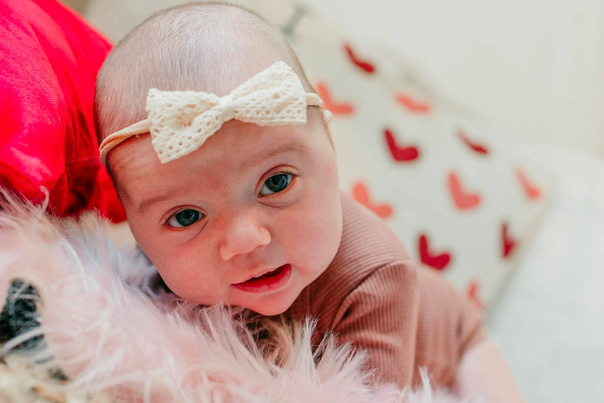 Katie is registered to the contest to win money with this photo: baby, baby_toddler_clothing, cap, child, costume_hat, event, eye, fashion_accessory, fictional_character, happy, hat, headband, headgear, headpiece, headwear, lip, person, pink, santa_claus, skin