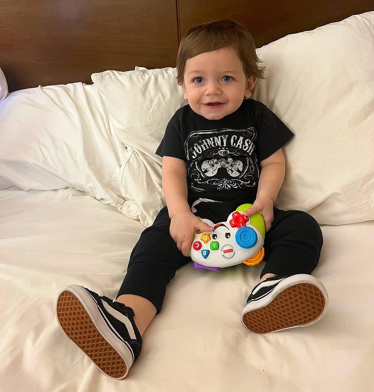 Adam is registered to the contest to win money with this photo: arm, baby_playing_with_toys, baby_toddler_clothing, comfort, cool, couch, face, fun, hairstyle, happy, head, human_body, joy, knee, person, shirt, sleeve, smile, t_shirt, textile