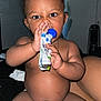 Vino is registered to the contest to win money with this photo: baby, diaper, indoor, child, snack_pouch, curious, sitting, person, skin, hand, face, wide_eyes, food, young_child, expression, furniture, room, shelf, lighting, casual