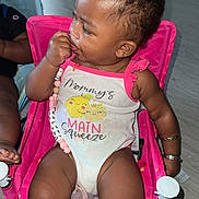Nalani joined the competition — help win amazing prizes! baby, child, onesie, pink_chair, pacifier, sitting, indoors, floor, bracelet, cute, clothing, infant, person, skin, hair, furniture, expression, hand, toy, accessory