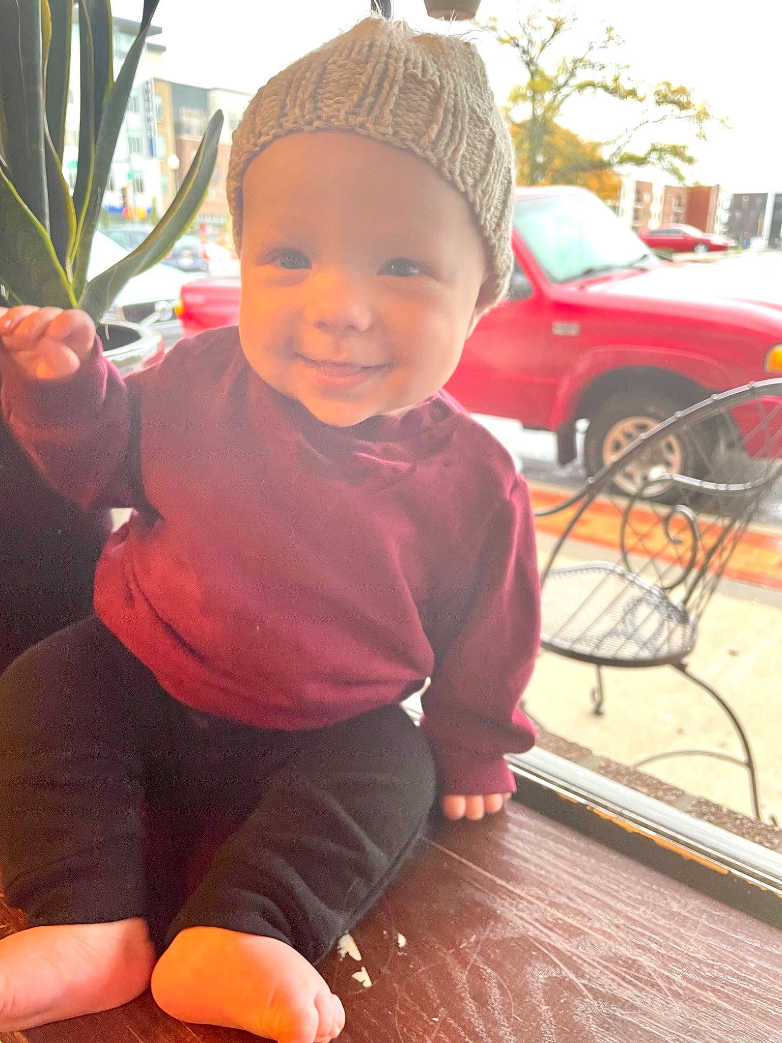 Adelaide is registered to the contest to win money with this photo: baby, baby_toddler_clothing, cap, car, flowerpot, fun, grass, happy, hat, headwear, joy, leisure, motor_vehicle, person, pink, plant, skin, smile, tire, toddler