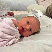 Angel participe au concours pour gagner de l'argent avec cette photo : baby, newborn, infant, person, face, eyes_open, gaze, mouth, hands, blanket, bedding, pillow, swaddle, close_up, lying_down, indoor, cozy, soft_toy, skin, pink