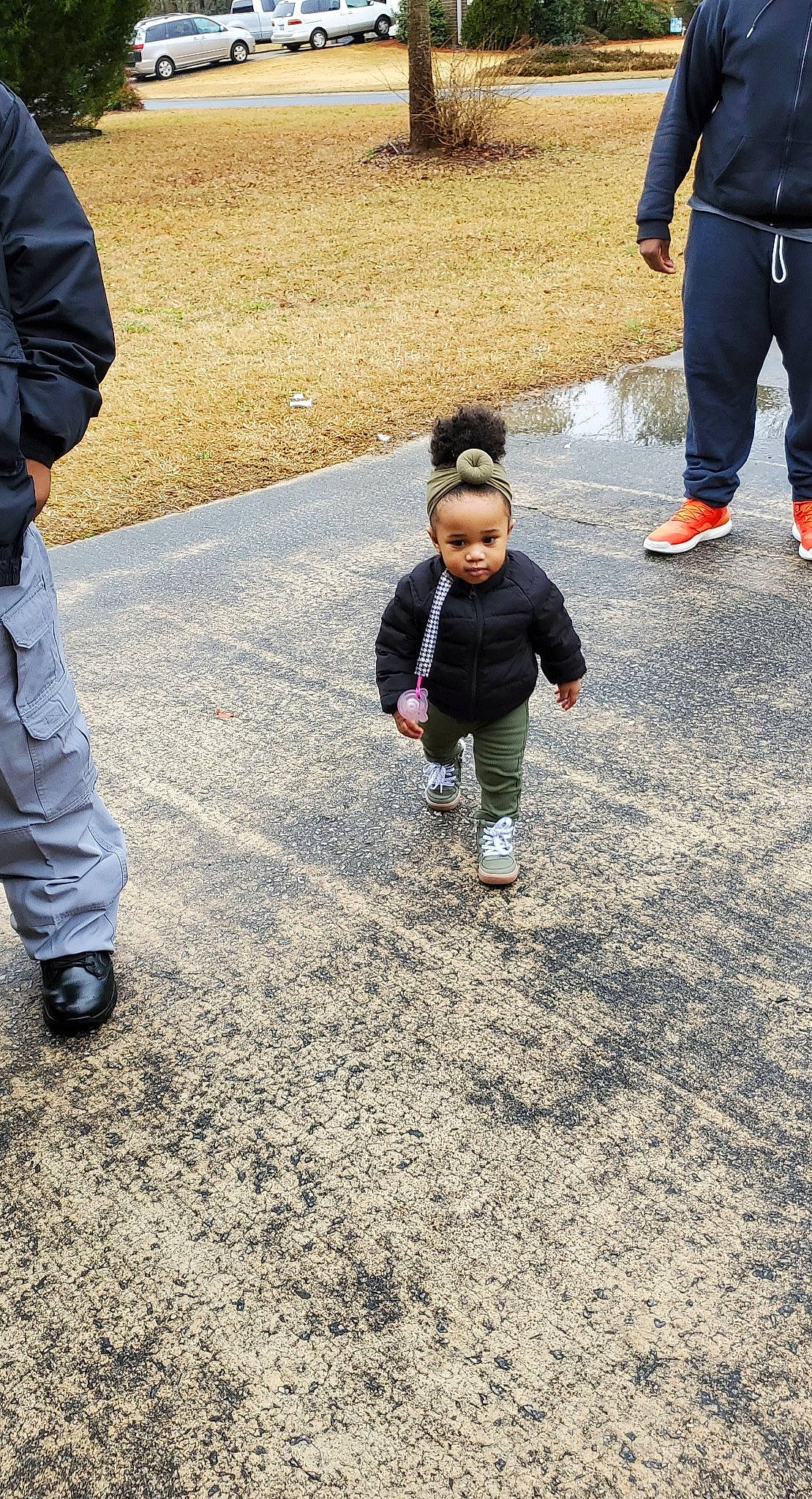 Londynn is registered to the contest to win money with this photo: asphalt, child, city, flooring, fun, gesture, grass, landscape, leisure, pedestrian, people_in_nature, person, recreation, road, road_surface, sand, shoe, sidewalk, sneakers, toddler