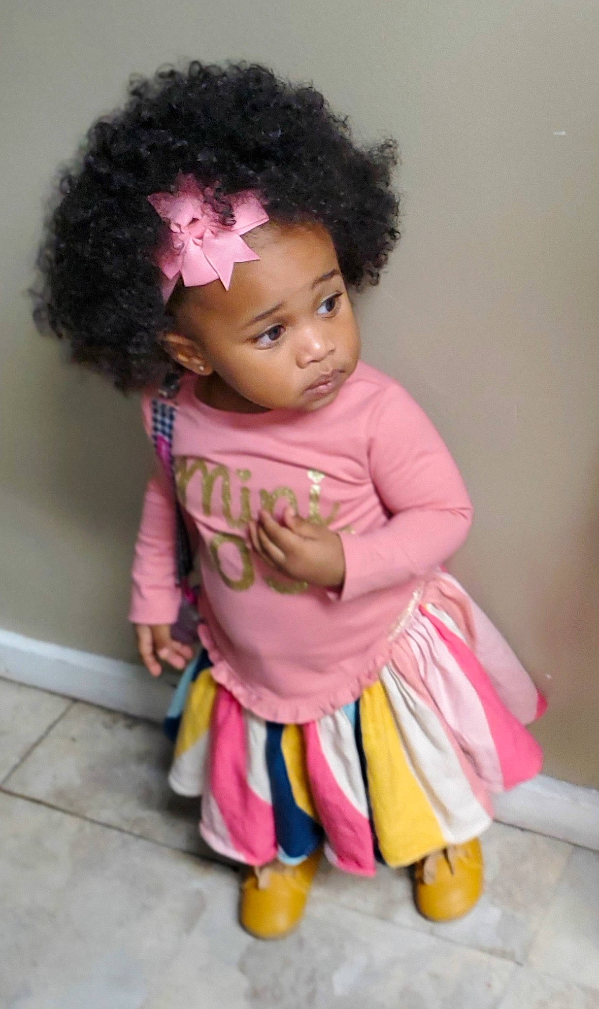 Londynn is registered to the contest to win money with this photo: afro, baby, baby_toddler_clothing, black_hair, cheek, child, child_model, costume, hairstyle, jheri_curl, magenta, person, pink, ringlet, skin, sock, toddler