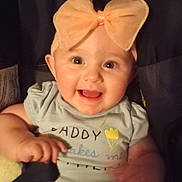 Lorabeth joined the competition — help win amazing prizes! baby, child, bow, headband, smile, happy, infant, toddler, clothing, face, portrait, cute, cheerful, sitting, indoor, person, light, background, expression, young