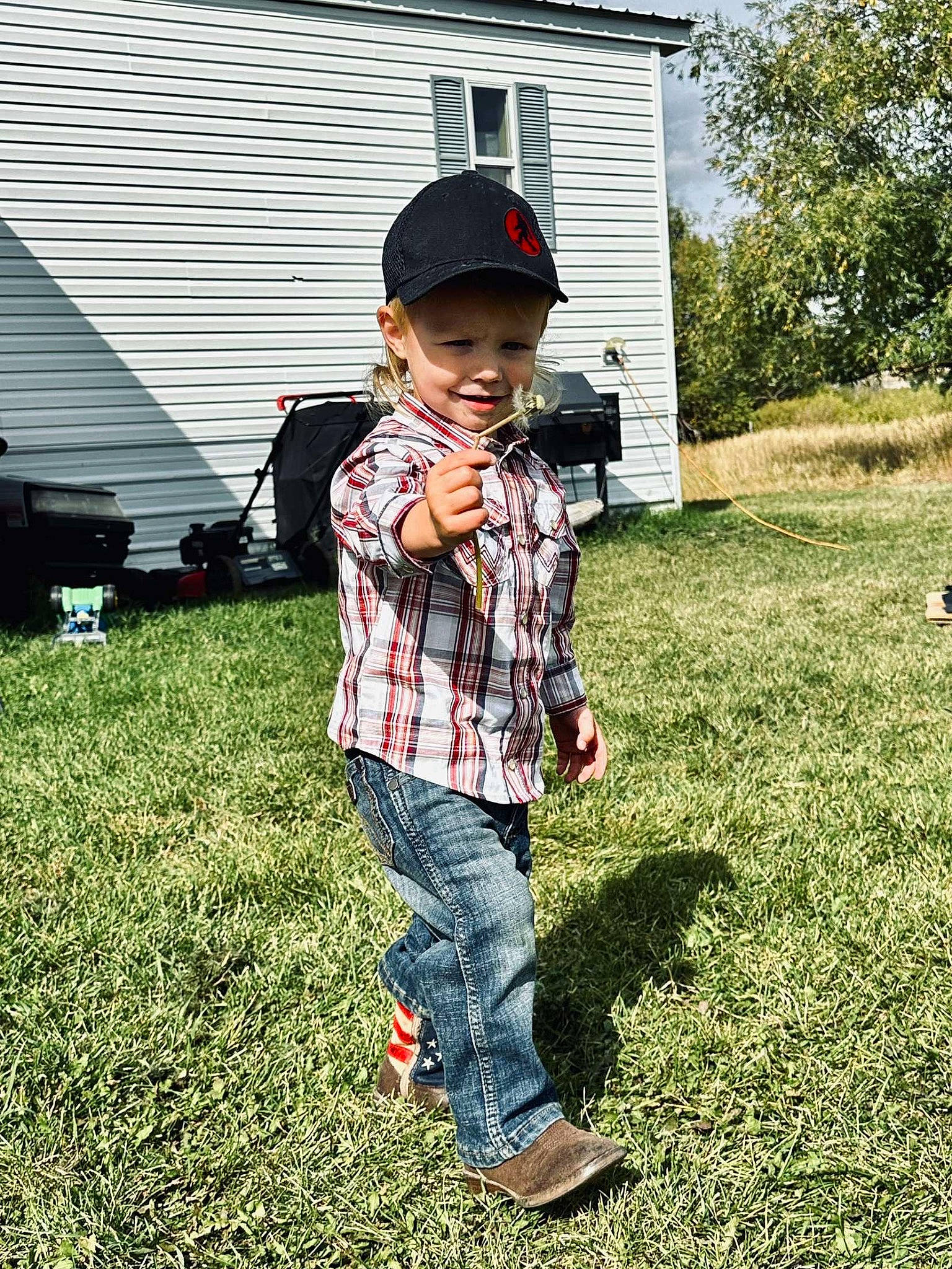 Remington is registered to the contest to win money with this photo: cap, denim, eyewear, grass, grassland, hairstyle, happy, headwear, joy, lawn, leisure, pattern, people_in_nature, person, plaid, plant, recreation, shoe, sleeve, t_shirt