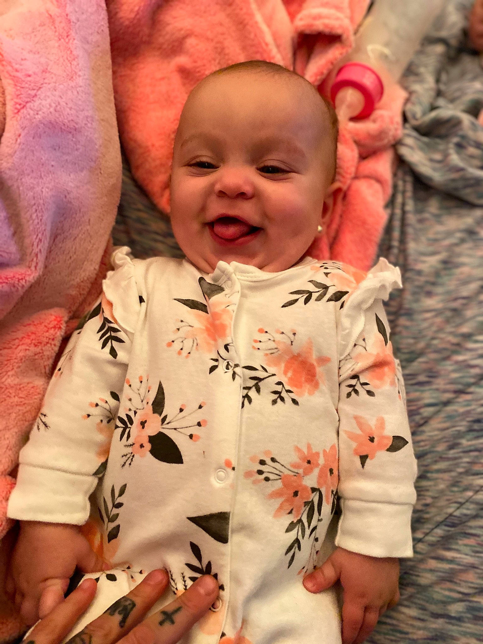 Gabriella is registered to the contest to win money with this photo: baby, baby_toddler_clothing, cheek, child, ear, eye, facial_expression, finger, forehead, happy, iris, lip, mouth, nose, person, pink, skin, sleeve, toddler, tongue