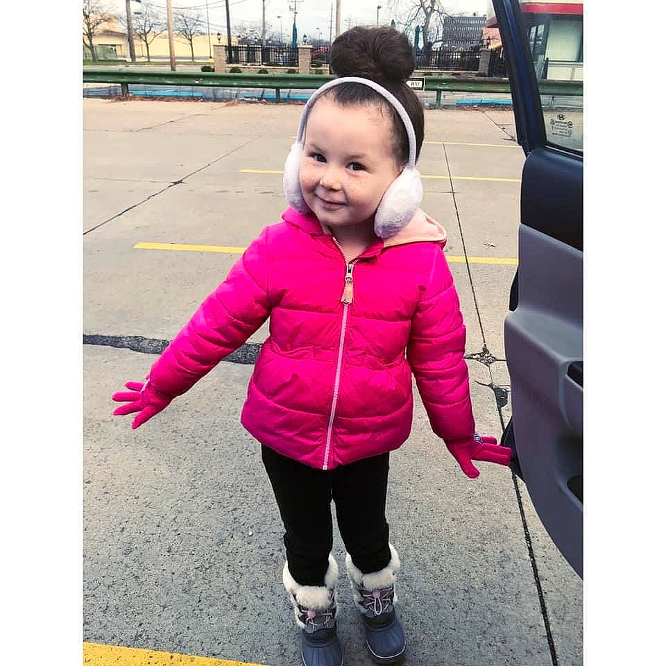 Liana is registered to the contest to win money with this photo: active_pants, baby_toddler_clothing, car_seat, child, child_model, cool, jacket, joy, magenta, outdoor_shoe, outerwear, person, pink, purple, snapshot, toddler, trousers, vehicle_door, walking_shoe, winter