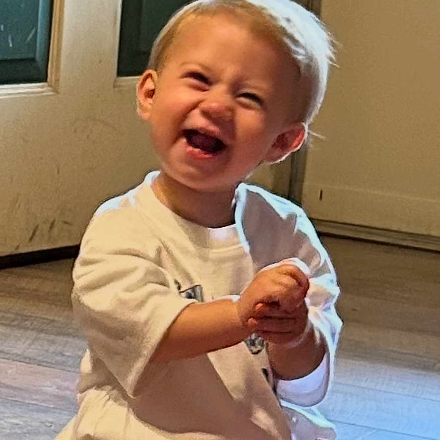 Elaineigh joined the competition — help win amazing prizes! baby, child, clapping, cute, diaper, door, expression, face, hands, happy, home, indoor, joyful, light, person, sitting, smiling, toddler, white_shirt, wooden_floor