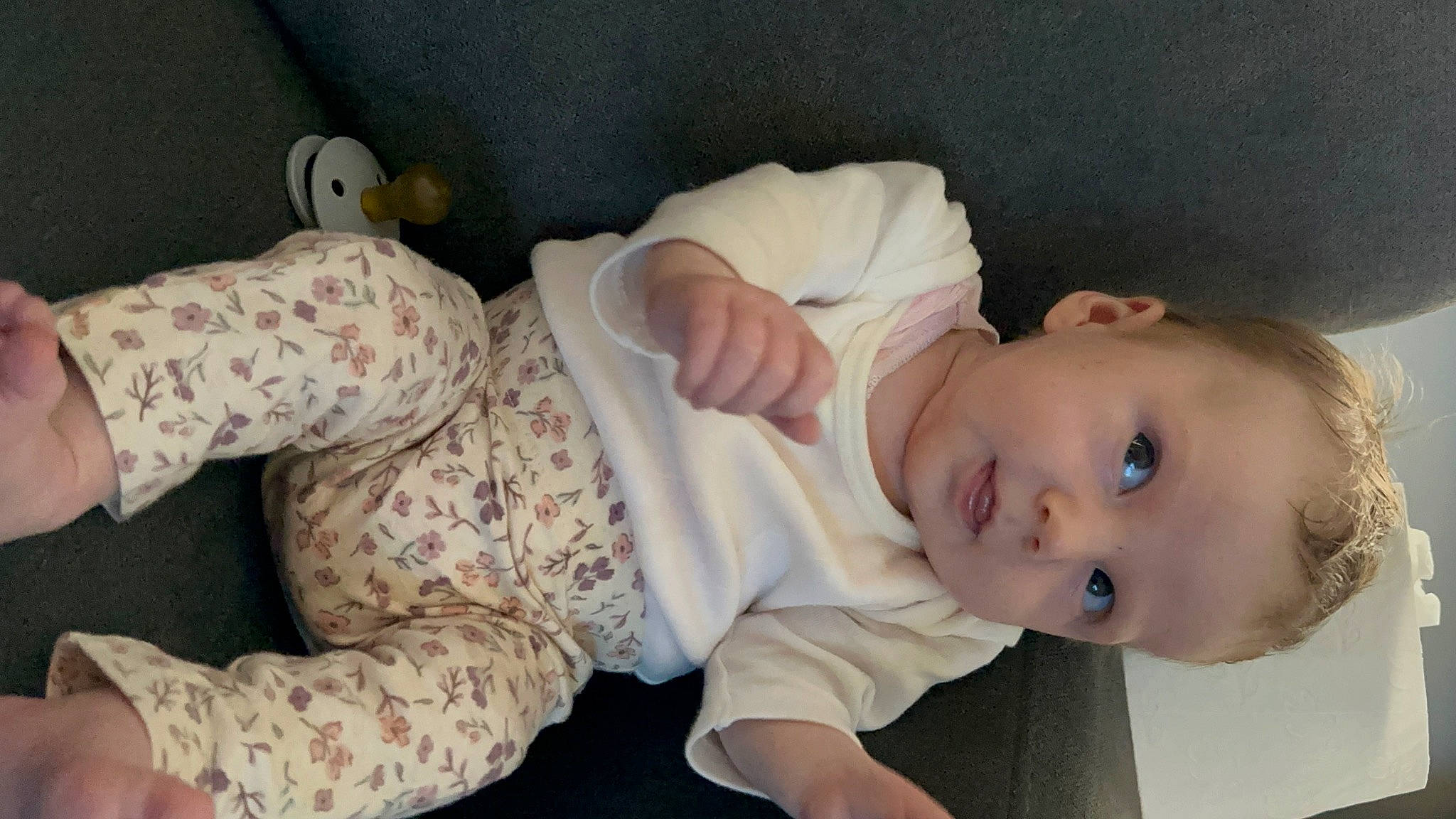 Anastasia is registered to the contest to win money with this photo: arm, baby, baby_products, baby_toddler_clothing, cheek, child, comfort, dress, flooring, human_body, linens, nose, person, portrait_photography, room, sitting, skin, sleeve, smile, toddler