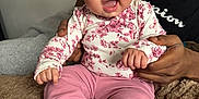 Maharmony joined the competition — help win amazing prizes! baby, child, infant, pink_clothing, headband, smiling, happy, blue_eyes, curly_hair, adult_hand, blanket, indoor, portrait, cute, sitting, cozy, support, family, person, closeup