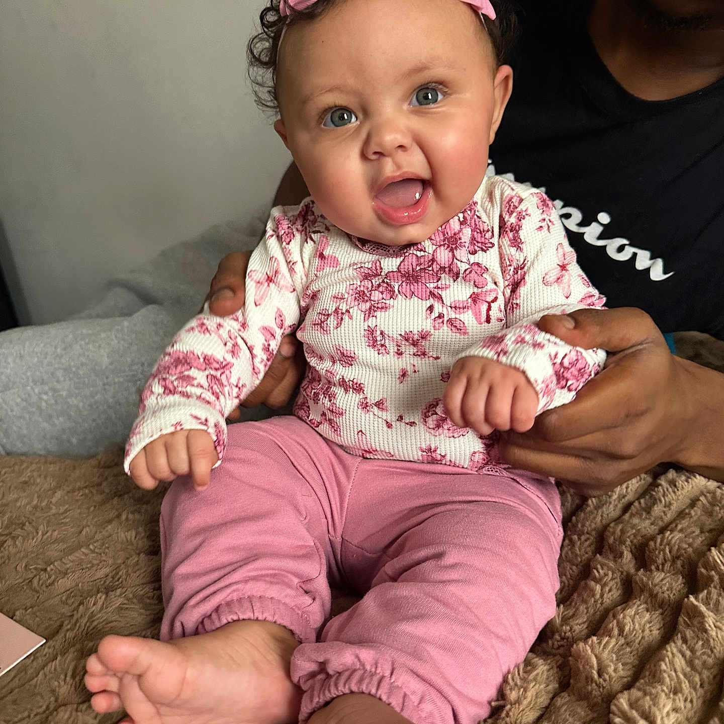 Maharmony joined the competition — help win amazing prizes! adult_hand, baby, blanket, blue_eyes, child, closeup, cozy, curly_hair, cute, family, happy, headband, indoor, infant, person, pink_clothing, portrait, sitting, smiling, support
