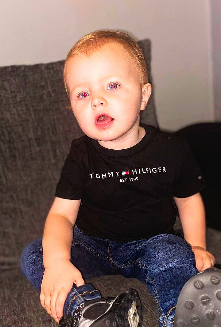 William is registered to the contest to win money with this photo: baby_toddler_clothing, cheek, child, comfort, denim, elbow, electric_blue, face, flash_photography, fun, head, human_leg, iris, knee, leg, person, sitting, skin, sleeve, surprise
