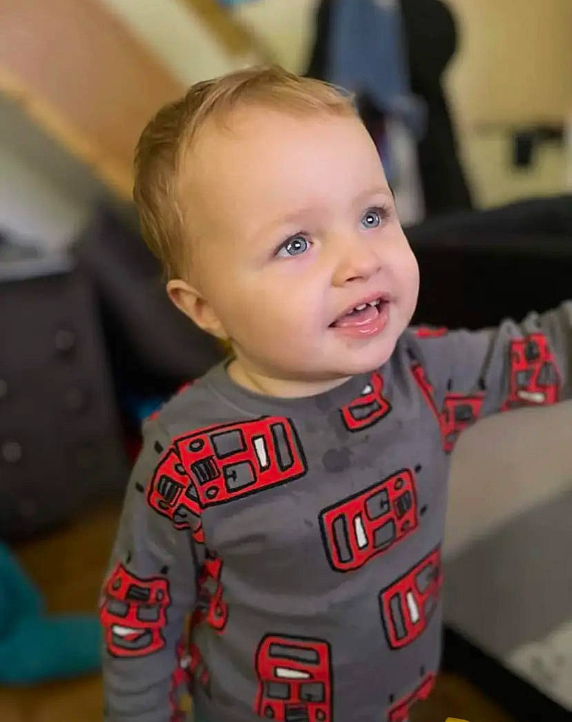 William is registered to the contest to win money with this photo: baby, baby_toddler_clothing, carmine, cheek, child, eyebrow, face, fun, happy, head, iris, lip, person, room, sitting, skin, sleeve, smile, t_shirt, toddler