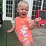 toddler, child, swimsuit, orange, unicorn, mermaid, bench, outdoor, happy, smiling, concrete, chalkboard, easel, door, window, glass, person, play, summer, daylight