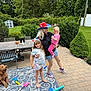 Maya joined the competition — help win amazing prizes! child, baby, woman, dog, outdoor, backyard, grass, trees, hat, shorts, barefoot, toy, rug, table, chair, greenery, patio, smile, family, play