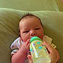 Dexter is registered to the contest to win money with this photo: baby, bottle, feeding, hand, cushion, infant, person, clothing, indoor, milk, newborn, cute, face, holding, resting, skin, soft, young, love, heart