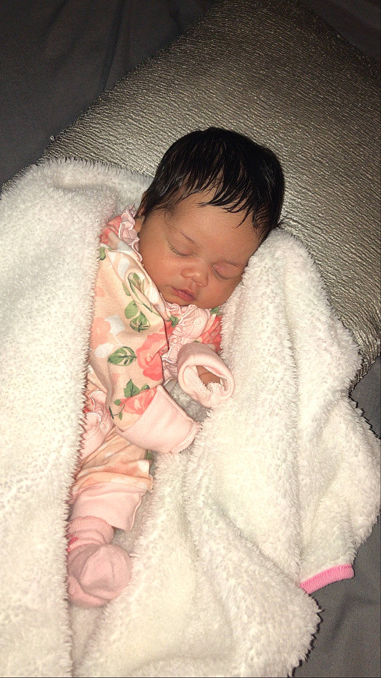 Nevaeh is registered to the contest to win money with this photo: baby, baby_products, baby_sleeping, baby_toddler_clothing, bedding, bedtime, cheek, child, comfort, eye, fur, gesture, linens, nose, outerwear, person, room, sitting, skin, sleeve