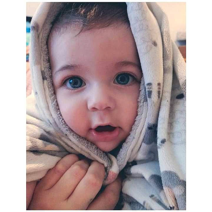 Isaiah is registered to the contest to win money with this photo: baby, cheek, comfort, ear, eyebrow, eyelash, face, gesture, happy, iris, lip, mouth, nose, outerwear, person, product, skin, sleeve, smile, textile