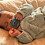 baby, bear_design, blanket, child, closeup, comfort, cozy, cute, face, hand, indoors, infant, newborn, onesie, pacifier, peaceful, rest, sleeping, soft, warm