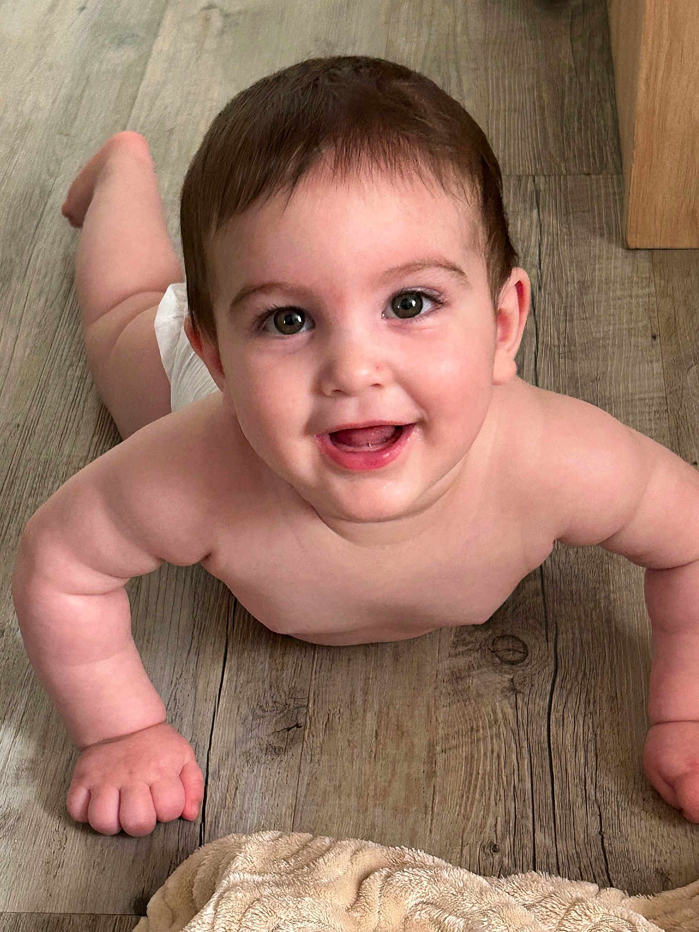 Ilyes a rejoint le concours — aidez-le/la à gagner de superbes lots ! baby, child, smile, face, skin, arm, hand, floor, wood, towel, happy, lying, indoors, human, cute, infant, expression, portrait, chubby, bright_eyes