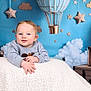 baby, infant, portrait, smile, teddy_bear, plush_toy, hot_air_balloon, stars, clouds, blue_background, blanket, sweater, hands, studio_shoot, suitcase, travel_theme, cute, cozy, child, decor