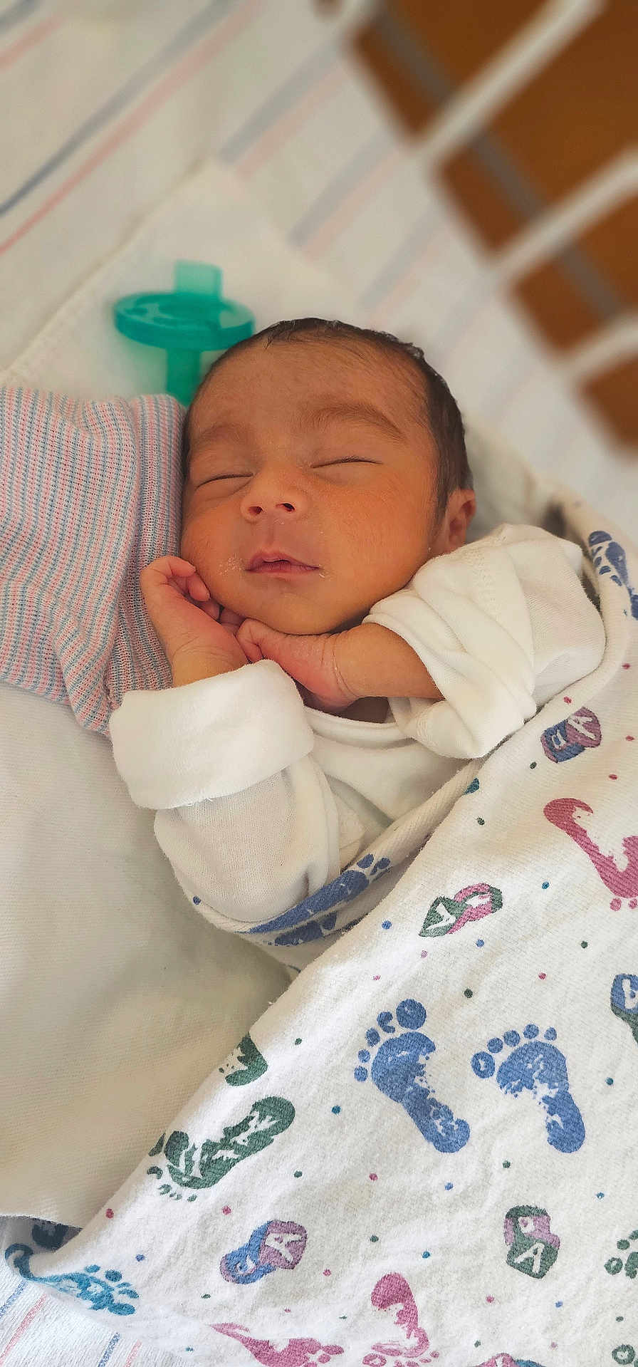 Damien Vincent is registered to the contest to win money with this photo: newborn, baby, sleeping, blanket, footprints, infant, nursery, swaddled, peaceful, cute, child, face, hand, resting, soft_lighting, closeup, portrait, white_clothing, pacifier, bed