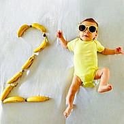 Louisa a rejoint le concours — aidez-le/la à gagner de superbes lots ! accessories, baby, banana, bodypart, clothing, face, finger, food, fruit, glasses, hand, hat, head, person, photography, plant, portrait, produce, sunglasses, swimwear