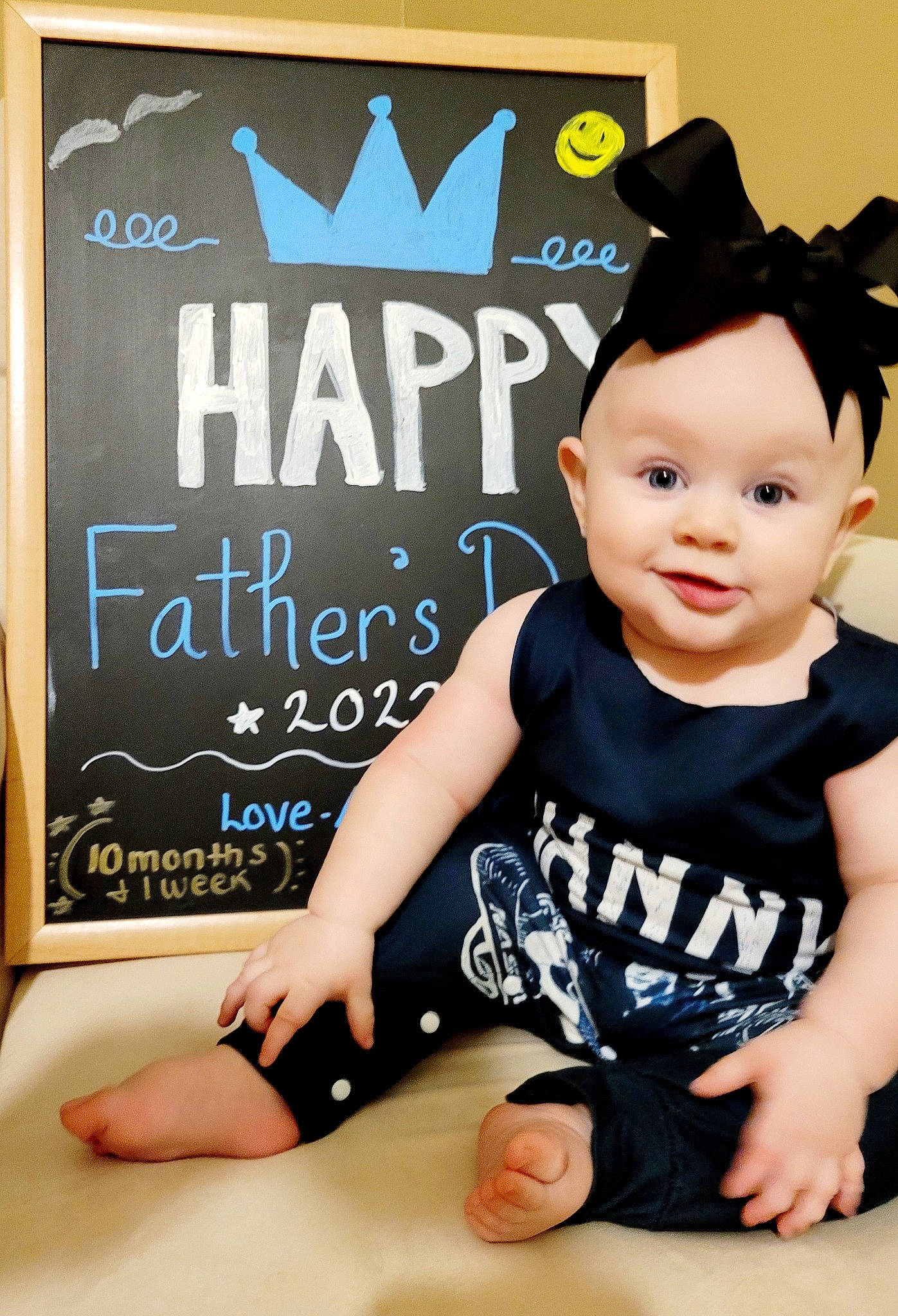 Adalynn joined the competition — help win amazing prizes! baby, baby_toddler_clothing, blackboard, cap, chalk, child, costume_hat, flash_photography, font, handwriting, happy, headwear, logo, pattern, person, picture_frame, poster, sitting, sleeve, smile
