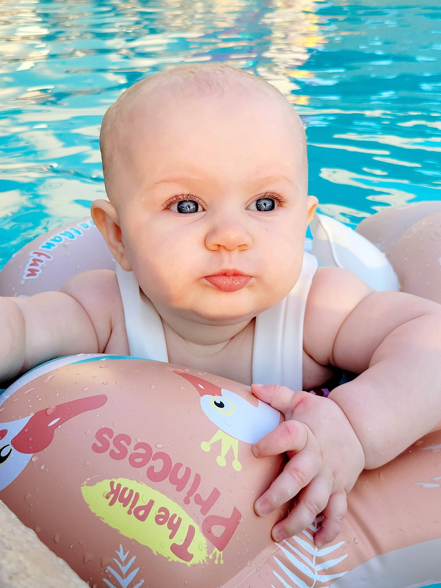 Adalynn is registered to the contest to win money with this photo: arm, azure, baby, baby_toddler_clothing, blue, cheek, eye, face, facial_expression, fun, hand, happy, head, joint, leisure, muscle, person, skin, toddler, water