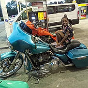 Memori is registered to the contest to win money with this photo: adult, car, child, clothing, female, footwear, gaspump, girl, light, machine, male, man, motor, motorcycle, person, pump, spoke, trafficlight, transportation, vehicle