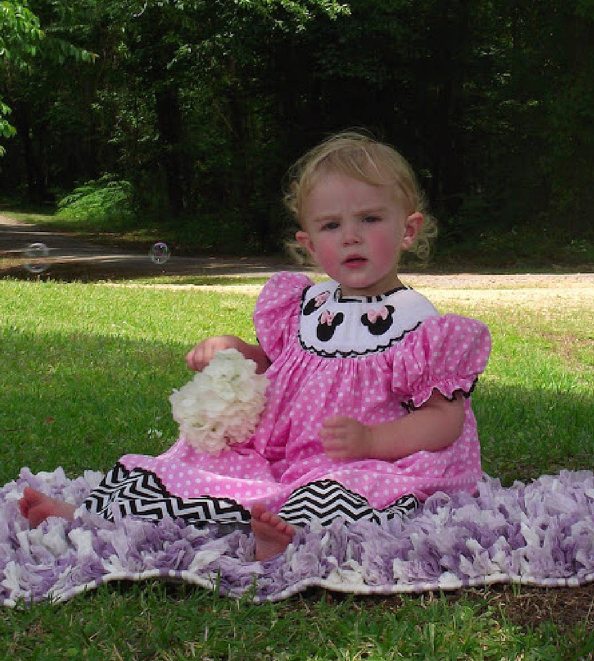 Blakelynn joined the competition — help win amazing prizes! baby, baby_products, baby_toddler_clothing, child, costume, dress, garden, grass, happy, lawn, magenta, pattern, person, pink, plant, ruffle, sitting, sleeve, toddler, tree