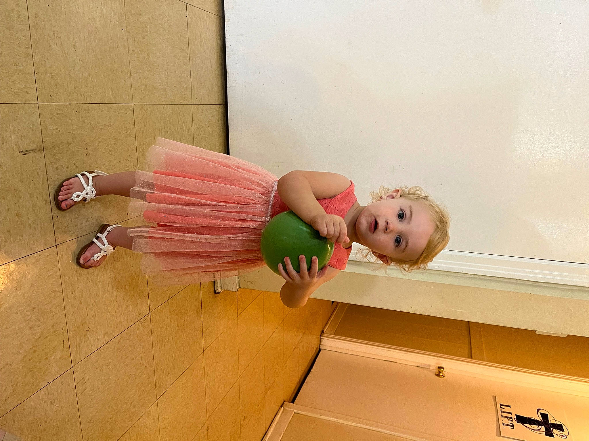 Blakelynn is registered to the contest to win money with this photo: child, dress, flooring, fun, happy, hardwood, human_leg, knee, magenta, peach, person, room, sandal, sitting, sock, surprise, thigh, toddler, toy, wood