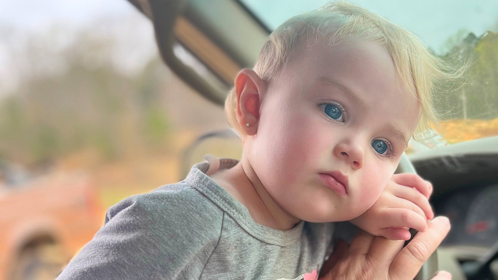 Blakelynn is registered to the contest to win money with this photo: baby, baby_toddler_clothing, cheek, child, eyelash, finger, fun, gesture, grass, hand, happy, lip, nose, person, plant, sitting, skin, sky, thumb, toddler