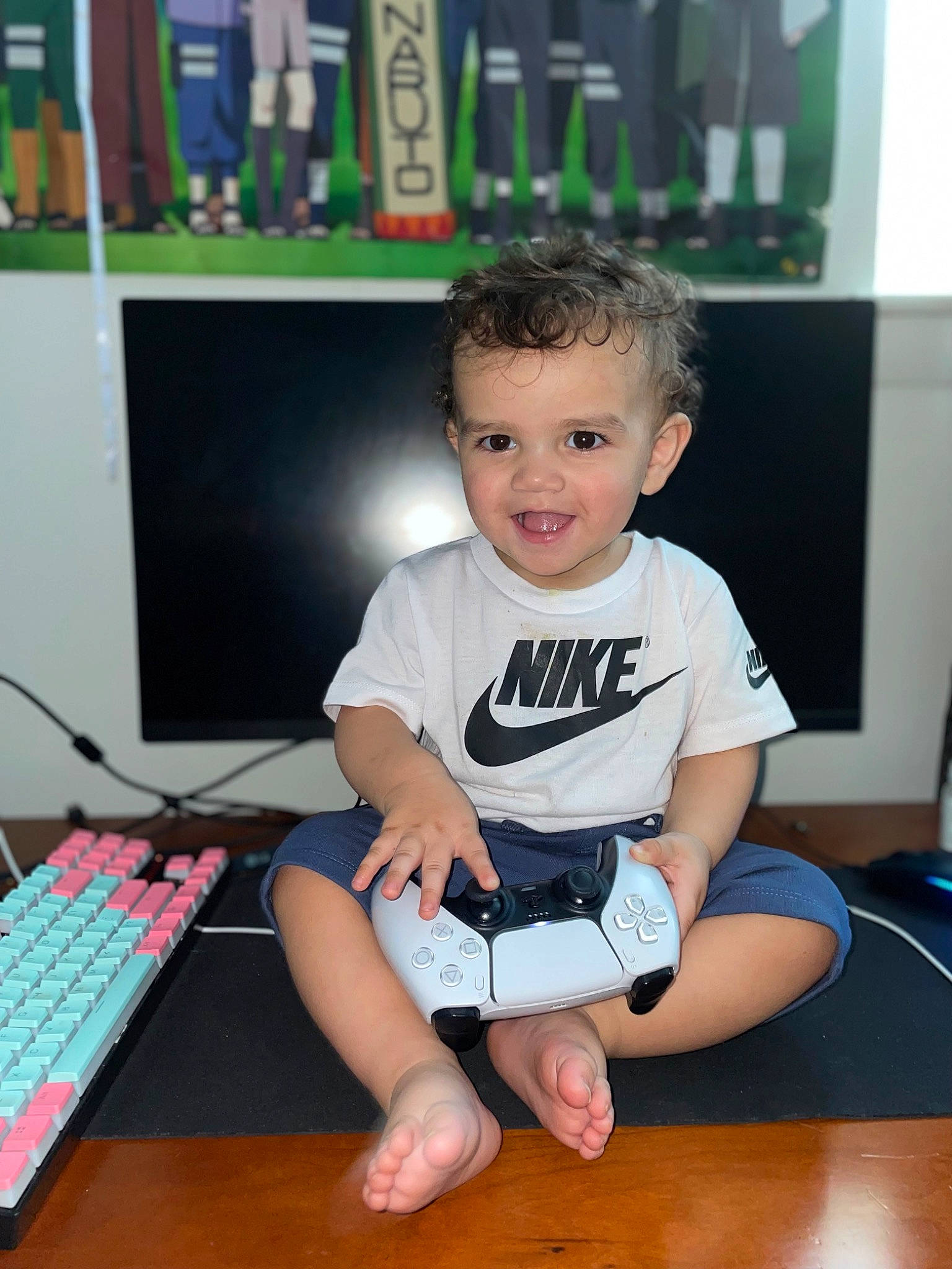 Alonzo is registered to the contest to win money with this photo: computer, computer_keyboard, computer_monitor, desk, desktop_computer, electronic_device, flooring, fun, gadget, happy, joy, knee, output_device, peripheral, person, shorts, smile, standing, t_shirt, table