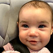 Norah joined the competition — help win amazing prizes! baby, smiling, blanket, car_seat, face, child, indoor, close_up, video_call, technology, wood_floor, adult, seatbelt, comfort, portrait, happy, person, candid, cute, cozy