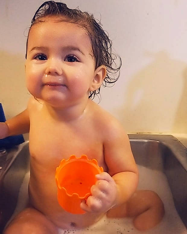 Jenny is registered to the contest to win money with this photo: bathing, cheek, child, face, finger, fun, head, infant, mouth, person, skin, toddler